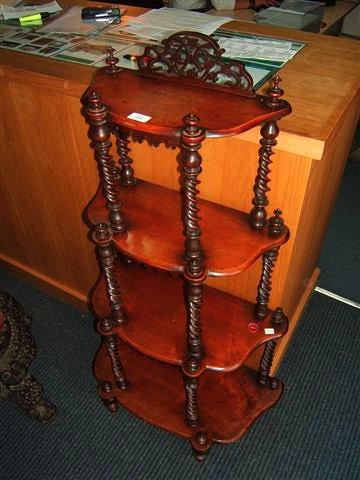 Appraisal: A Victorian walnut four tier whatnot with shaped shelves and