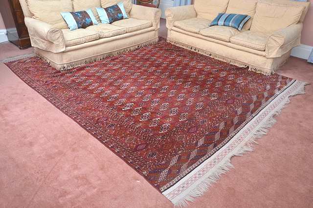 Appraisal: A LARGE BOKHARA RED GROUND CARPET with allover elephant's foot