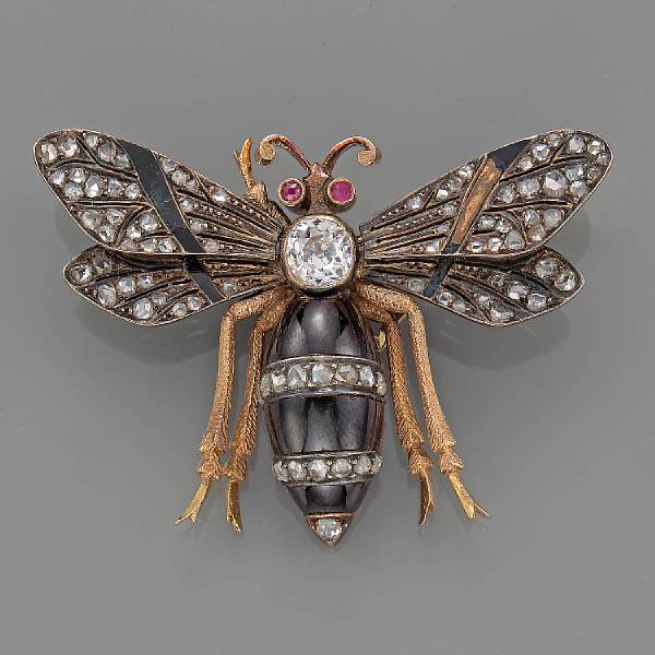 Appraisal: A diamond garnet enamel ruby and silver-topped gold moth brooch