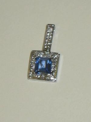 Appraisal: A SAPPHIRE AND DIAMOND PENDANT the princess cut pale blue