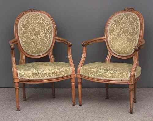 Appraisal: A pair of French walnut framed oval back open arm