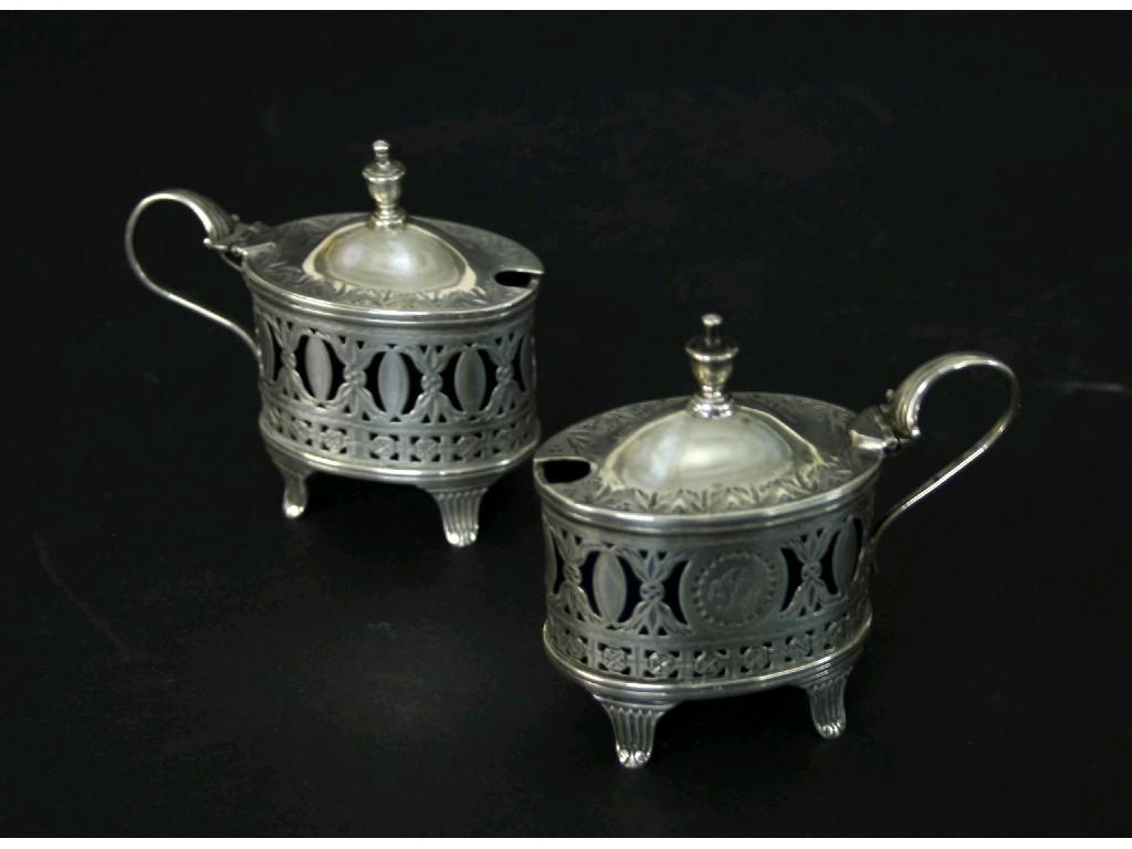 Appraisal: Good pair of Victorian silver mustards pierced with geometric garlands