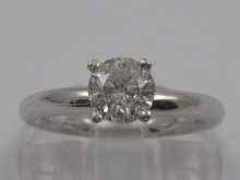 Appraisal: A white metal tests ct gold diamond solitaire ring the