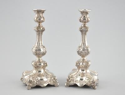 Appraisal: A Pair of Silver Plated Repousse Candlesticks The matching silver