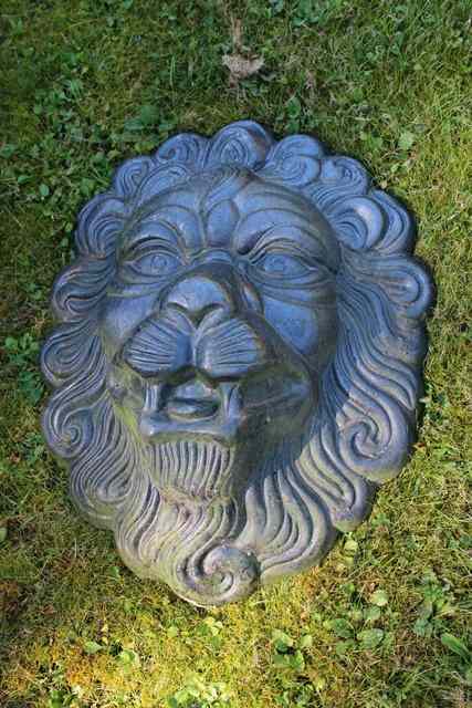 Appraisal: A PAIR OF BLACK GLAZED POTTERY LION MASKS high