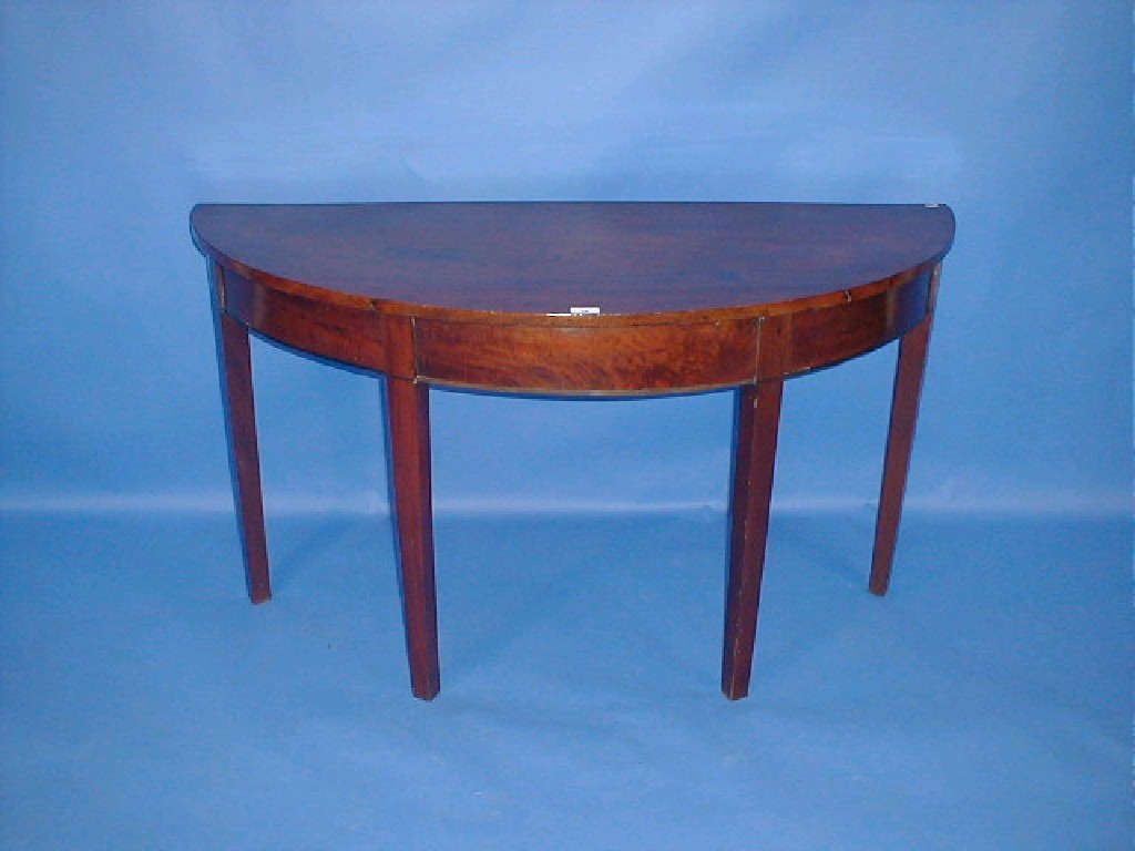 Appraisal: A George III mahogany demi lune side table with flamed