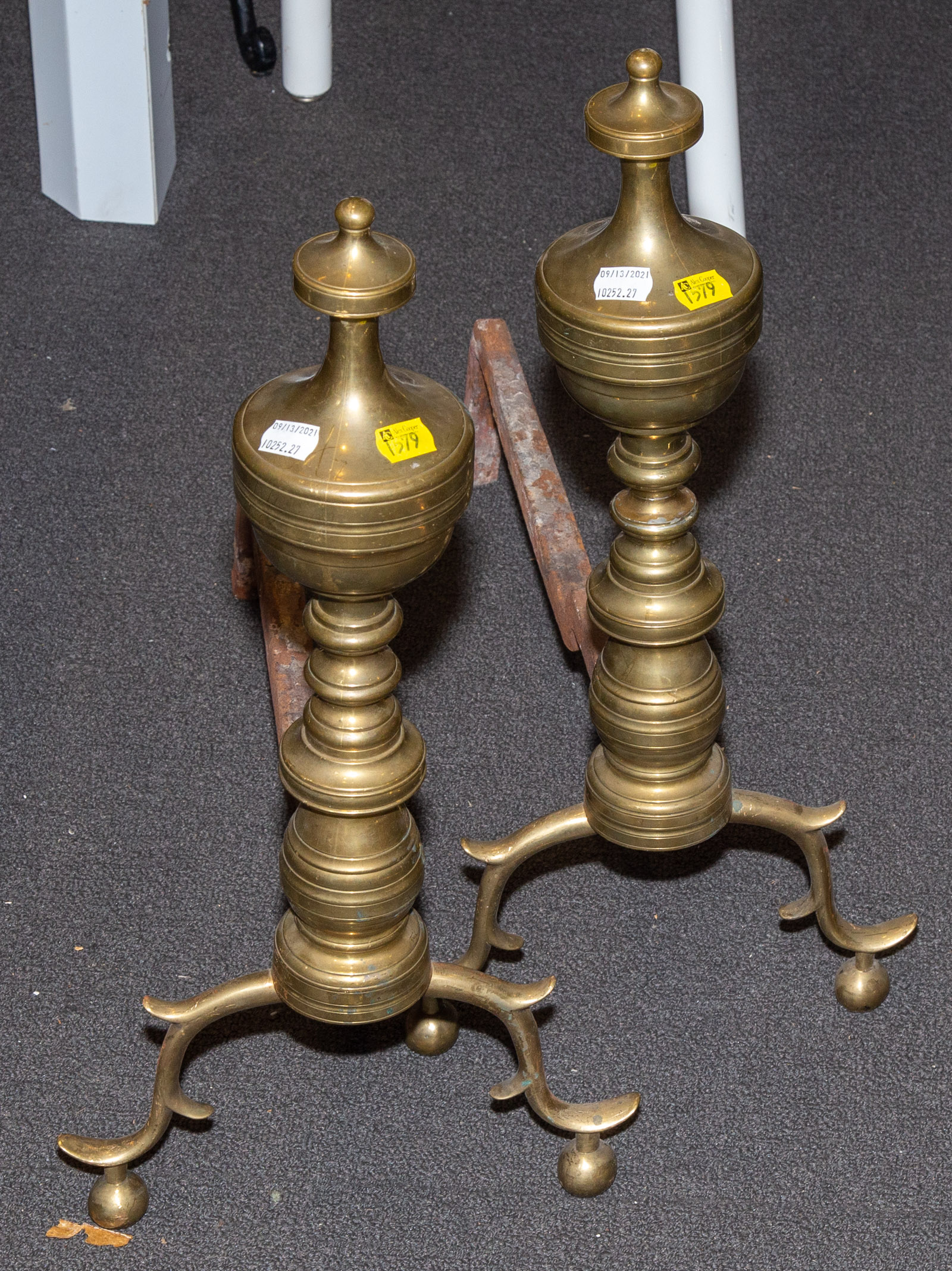 Appraisal: A PAIR OF CHIPPENDALE INFLUENCED BRASS ANDIRONS st quarter th