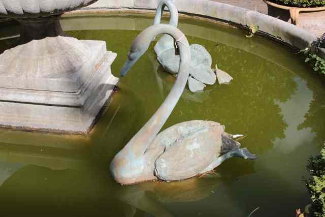 Appraisal: A PAIR OF BRONZE SCULPTURES of swans swimming in water