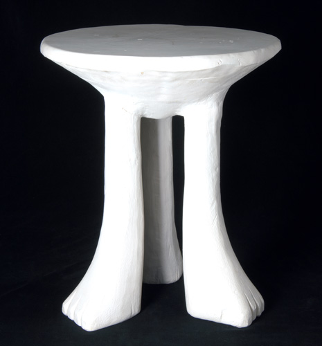 Appraisal: JOHN DICKINSON Three-legged African table of painted plaster c Signed