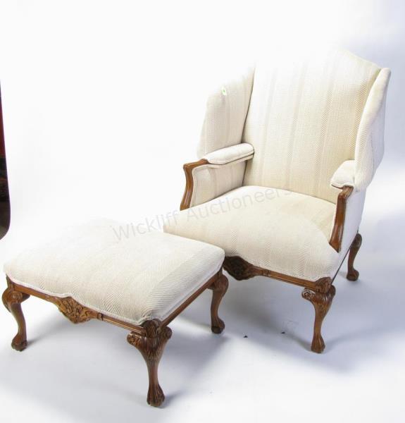 Appraisal: A vintage period-style fireside chair and ottoman with cream upholstery