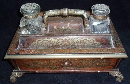 Appraisal: A Regency rosewood and brass inlaid inkstand fitted two inkwells