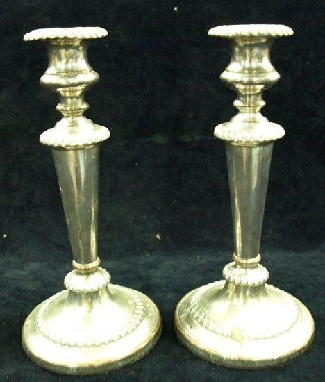 Appraisal: A pair of candlesticks the circular drip pans above bulbous