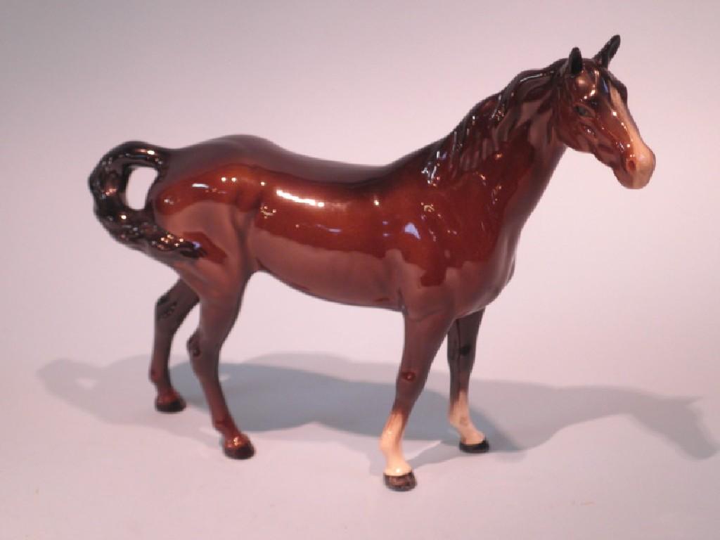 Appraisal: A Beswick brown glazed horse with twisted tail