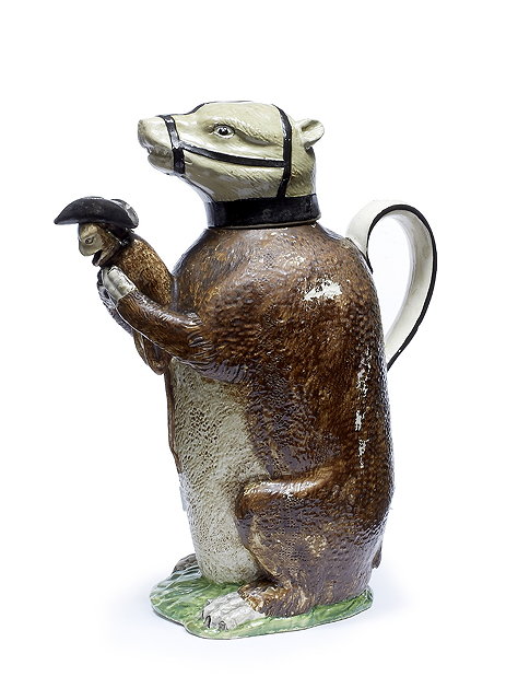 Appraisal: A Staffordshire Pearlware bear baiting jug and coverearly th Centurythe