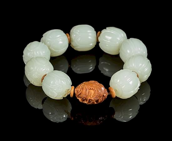 Appraisal: A White Jade Lotus-Shaped Bead Bracelet Diameter of bead inches