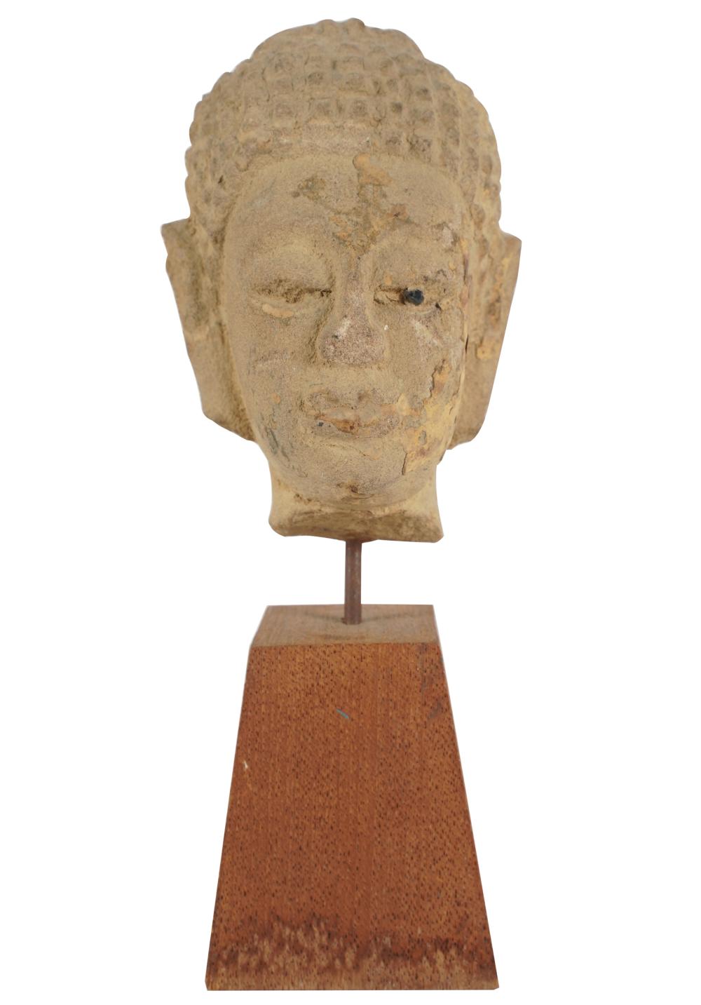 Appraisal: CARVED STONE HEAD OF BUDDHAmounted to a wooden plinth inches