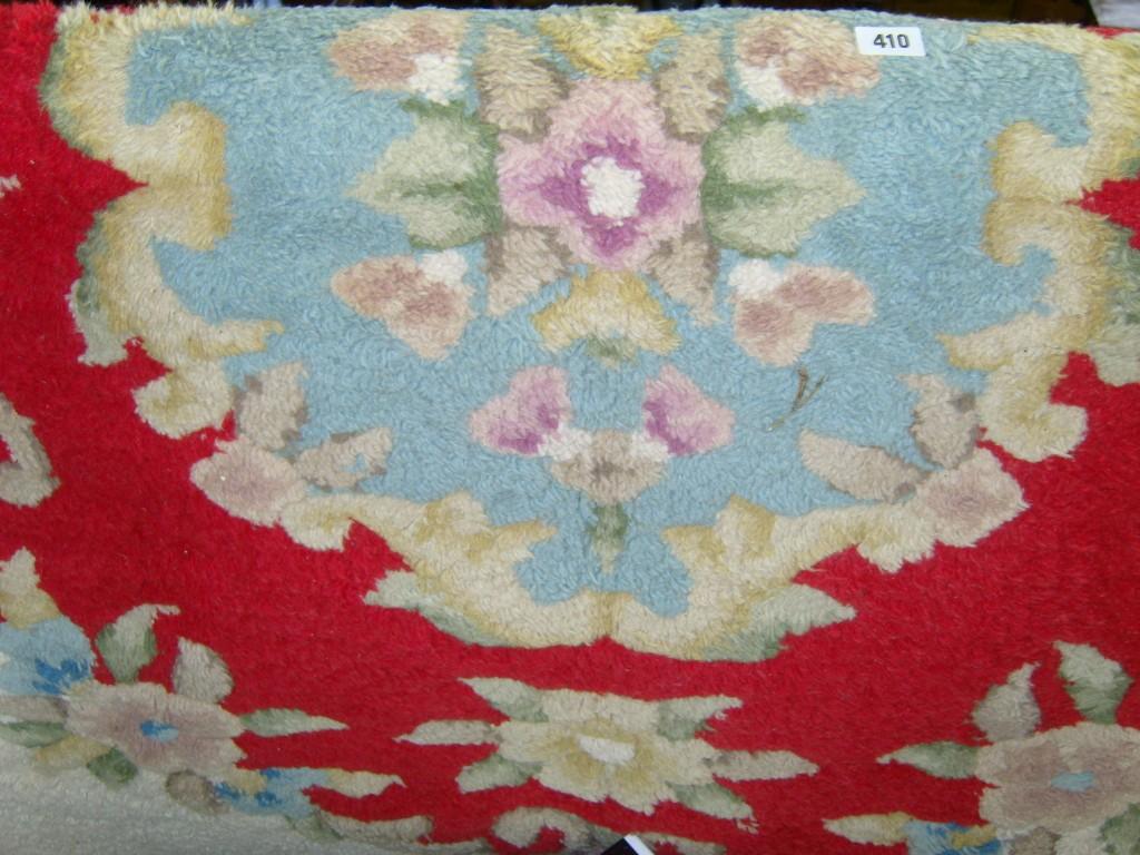 Appraisal: A cream ground wool carpet with central floral medallion in