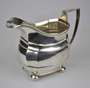 Appraisal: A Georgian style silver milk jug on bun feet Nathan