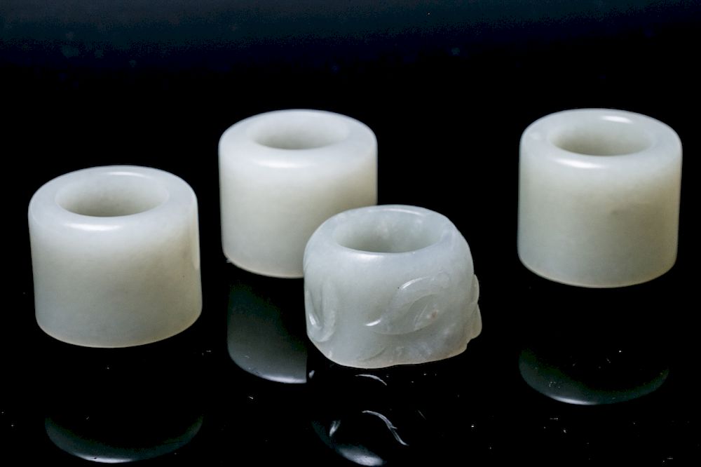 Appraisal: A SET OF FOUR JADE THUMB RINGS The set comprising