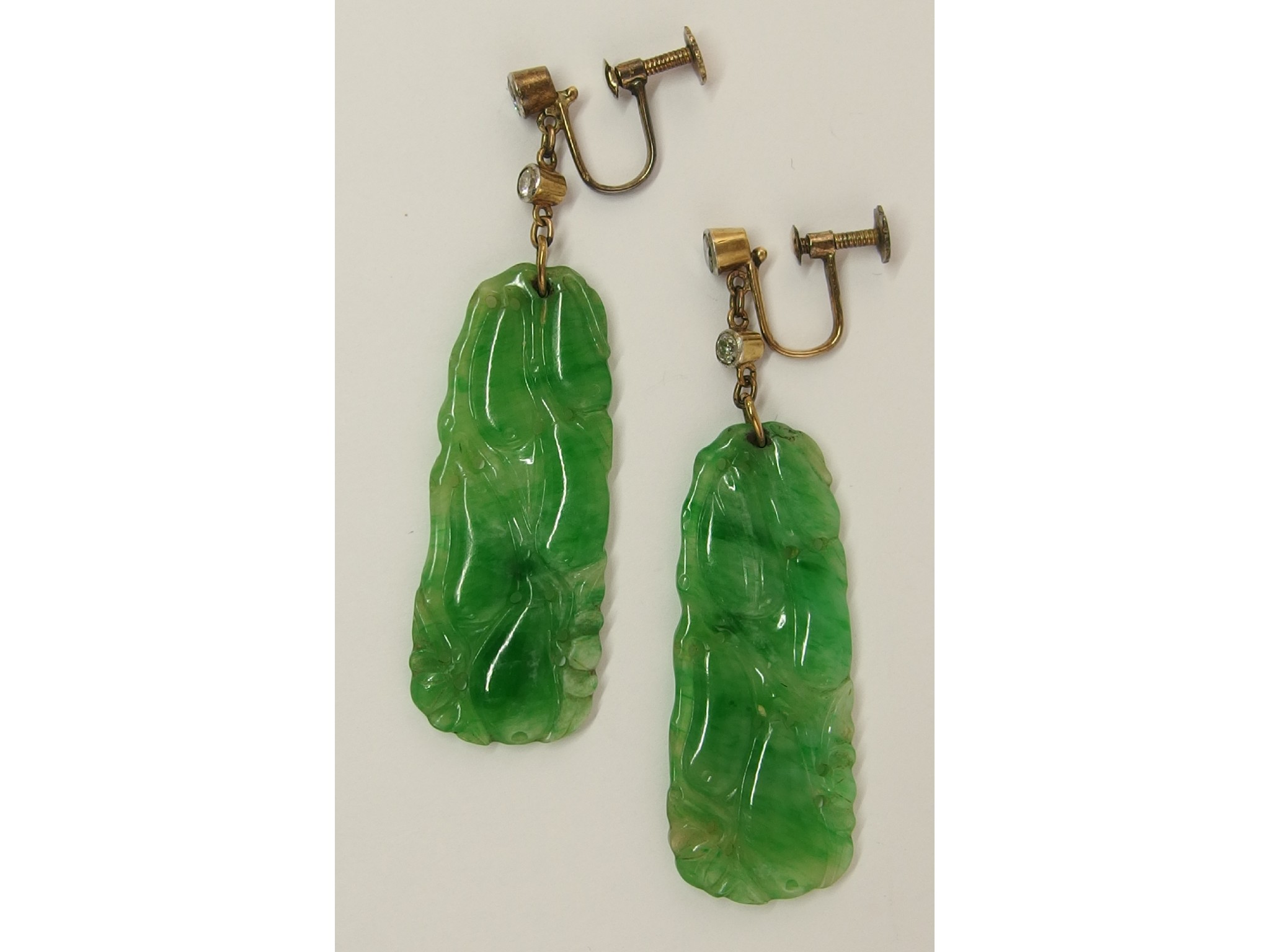 Appraisal: A pair of diamond and Chinese green hardstone earringscarved with