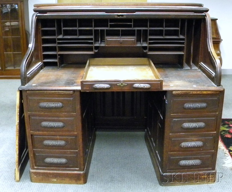 Appraisal: Late Victorian Carved Oak Roll-top Desk with fitted slot interior