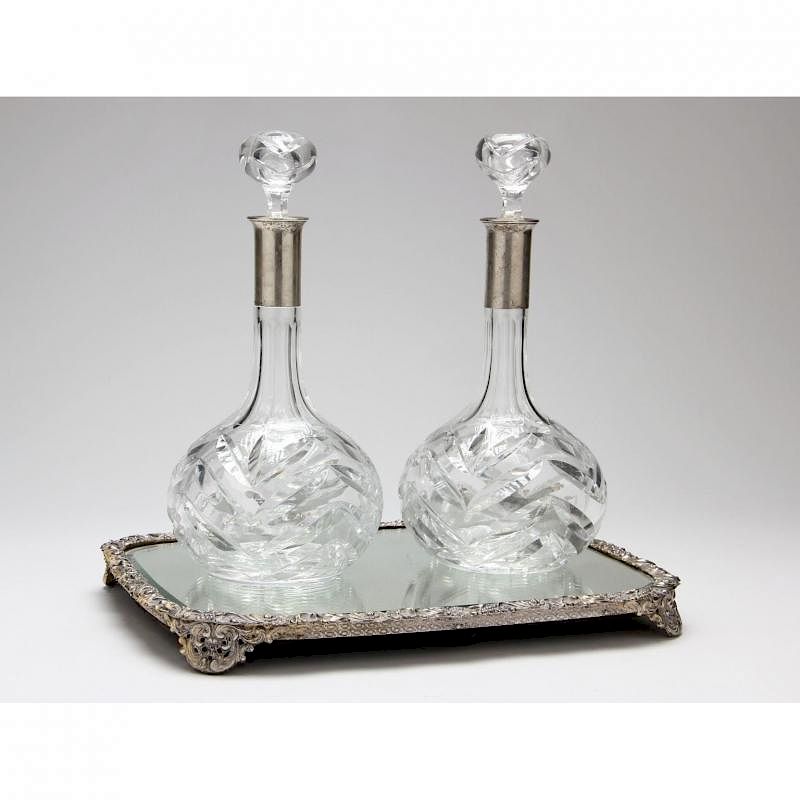 Appraisal: Pair of Silver Mounted Cut Glass Decanters Mirrored Plateau the