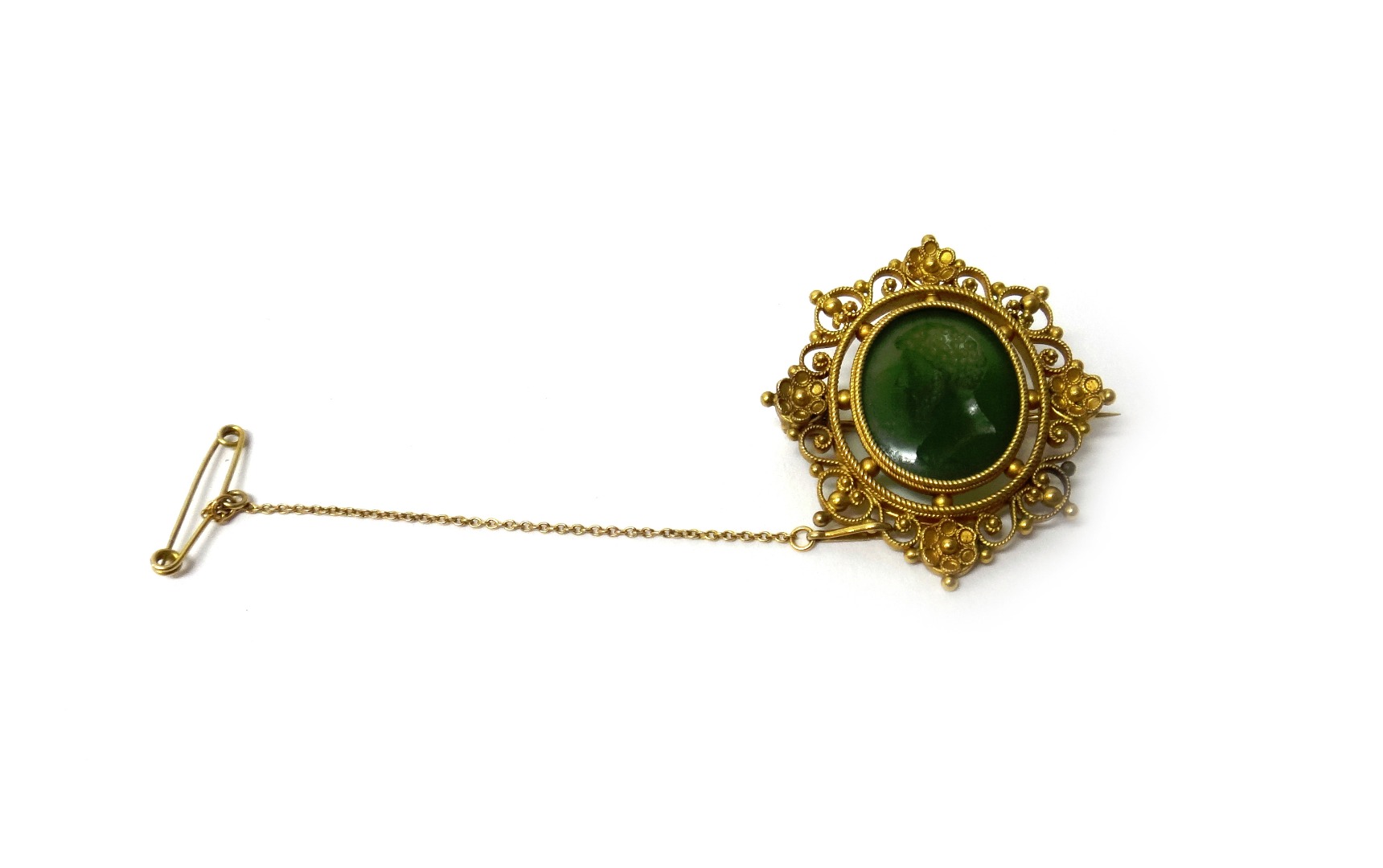 Appraisal: A gold mounted carved green hardstone oval intaglio brooch carved