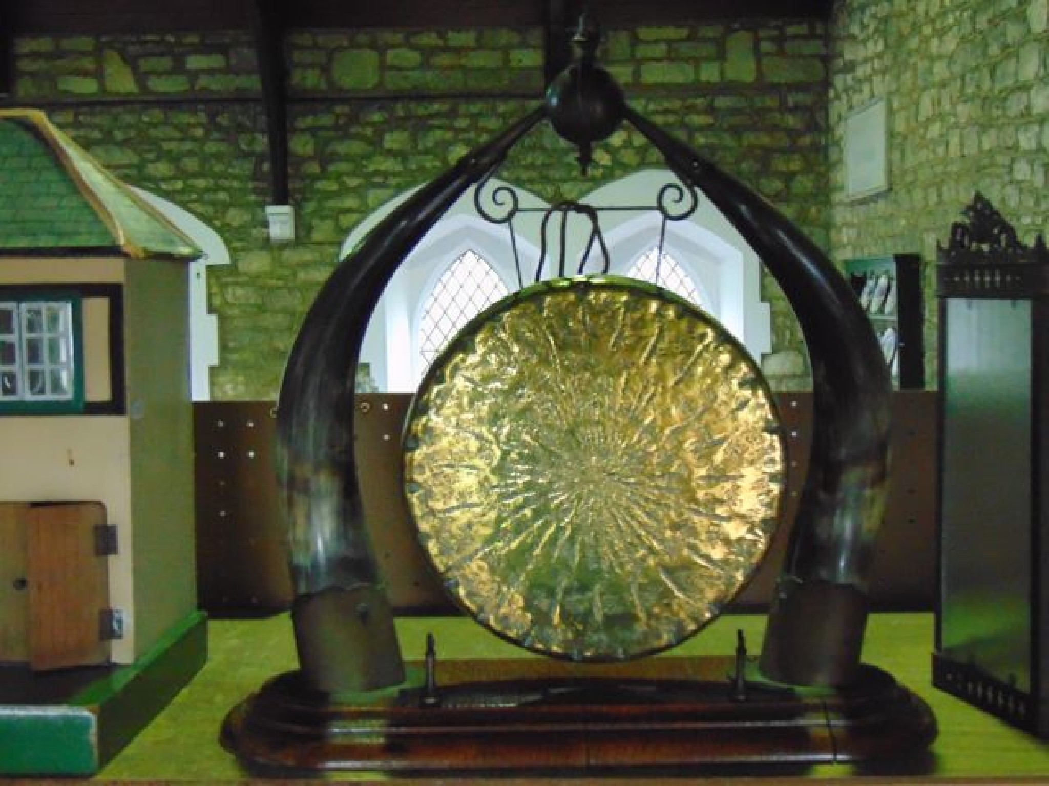 Appraisal: A Victorian brass table gong with textured finish flanked and