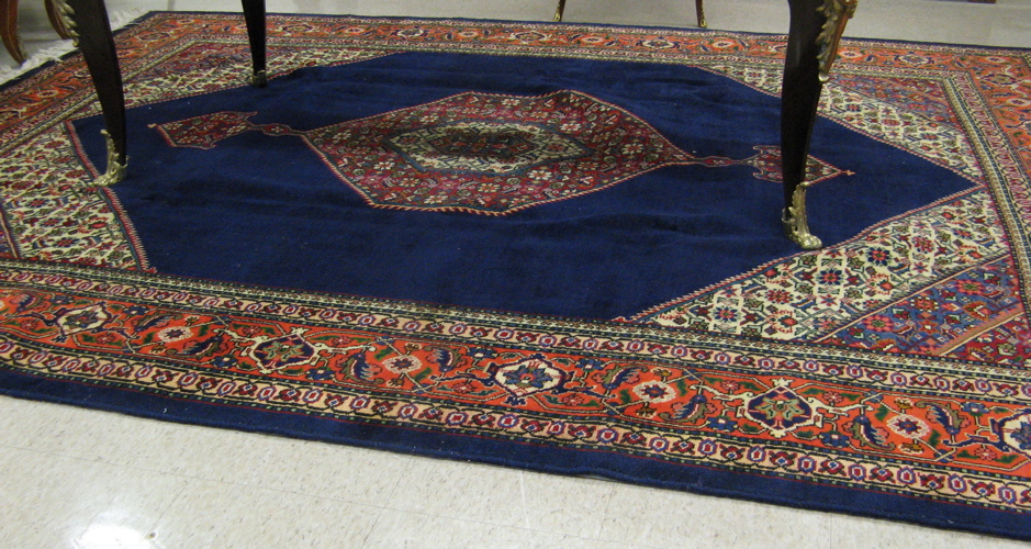 Appraisal: PERSIAN TABRIZ CARPET the hexagonal plain blue field centering a