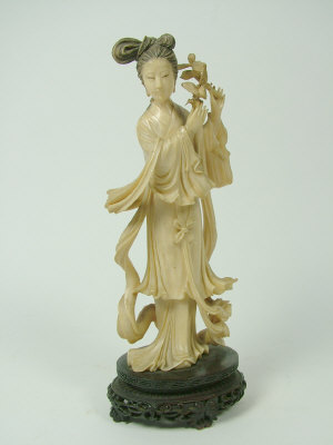 Appraisal: An oriental carved ivory figure of Kuan Yin on a