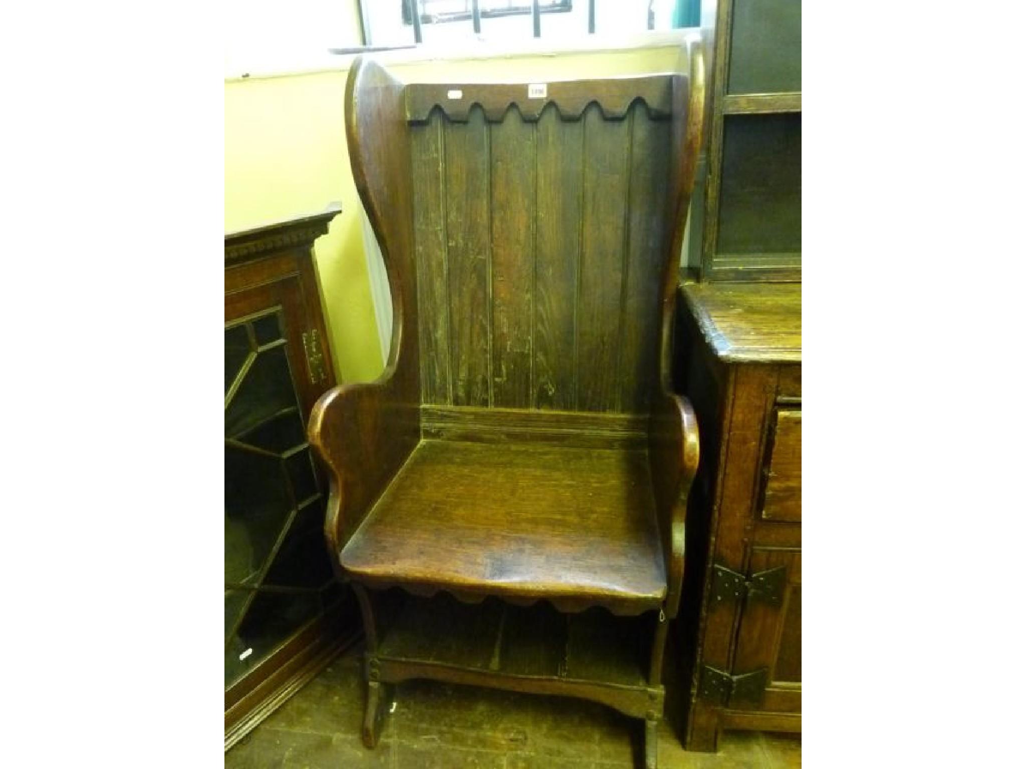 Appraisal: An Old English style oak wing and panelled back chair