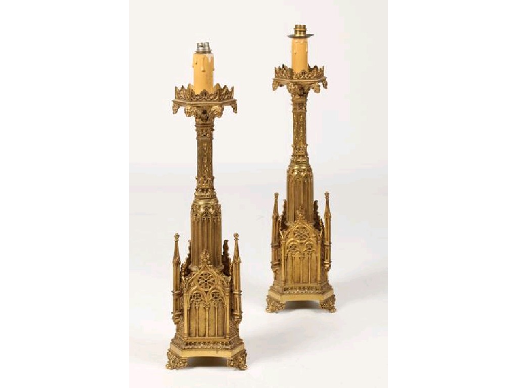 Appraisal: A PAIR OF GILT METAL GOTHIC REVIVAL CANDLESTICKS with octagonal