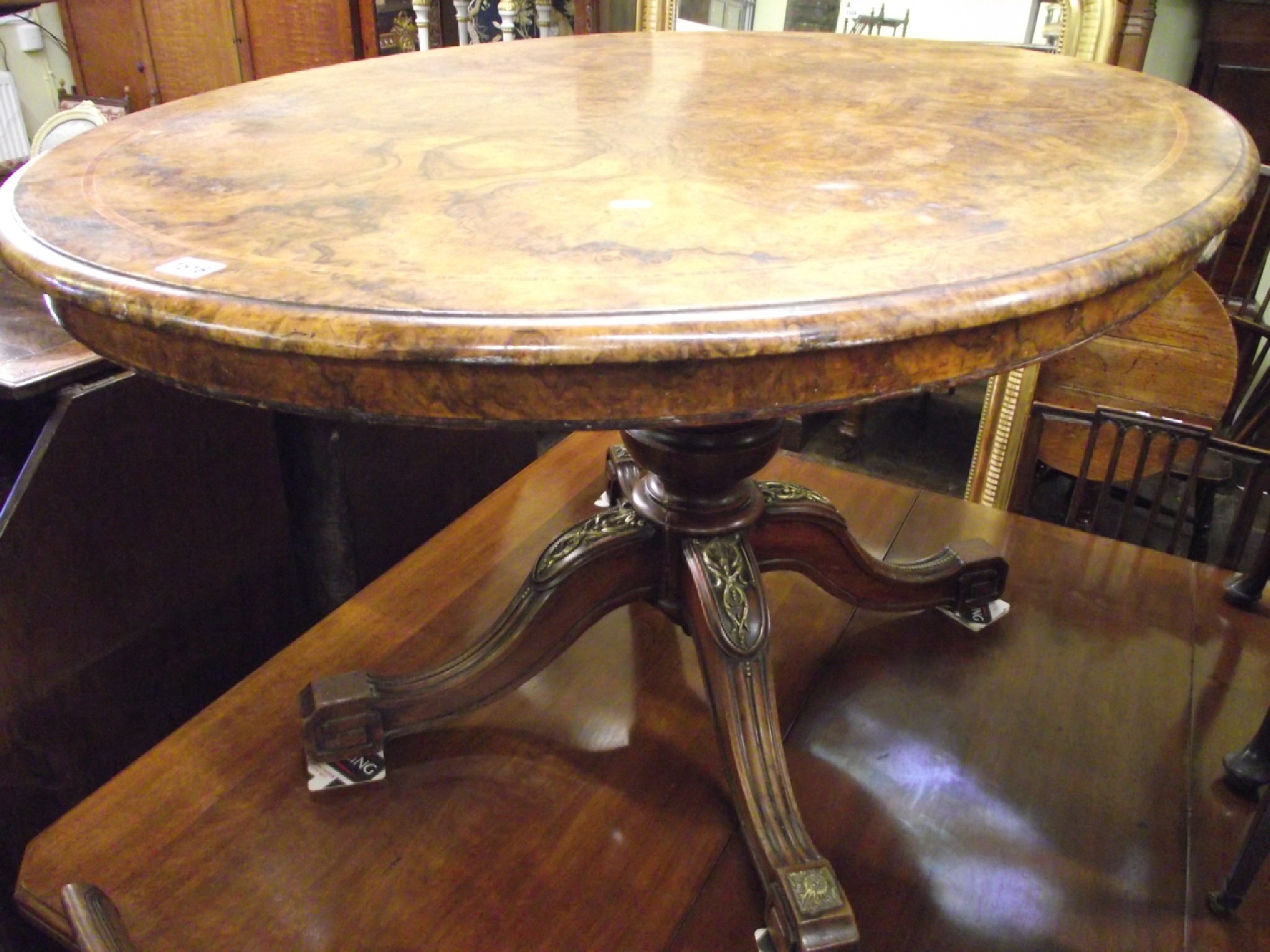 Appraisal: A Victorian walnut and burr walnut loo table the oval