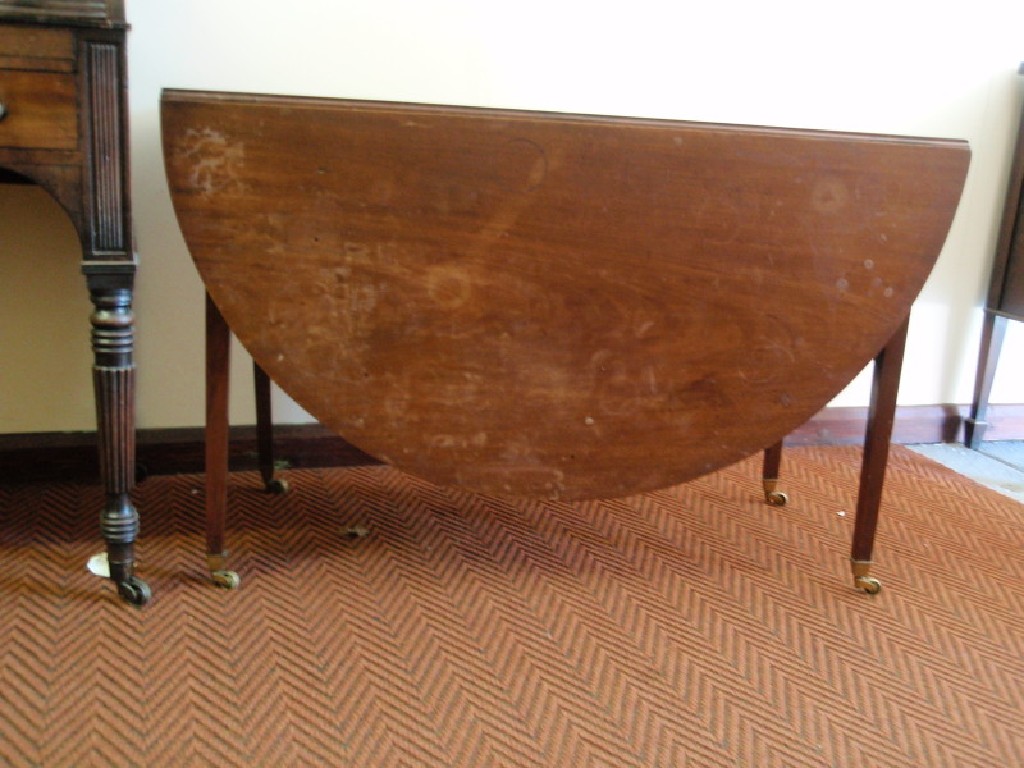 Appraisal: A Regency mahogany drop leaf table with oval top square