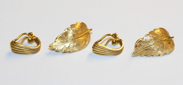 Appraisal: A PAIR OF LEAF SHAPED EAR CLIPS stamped and a