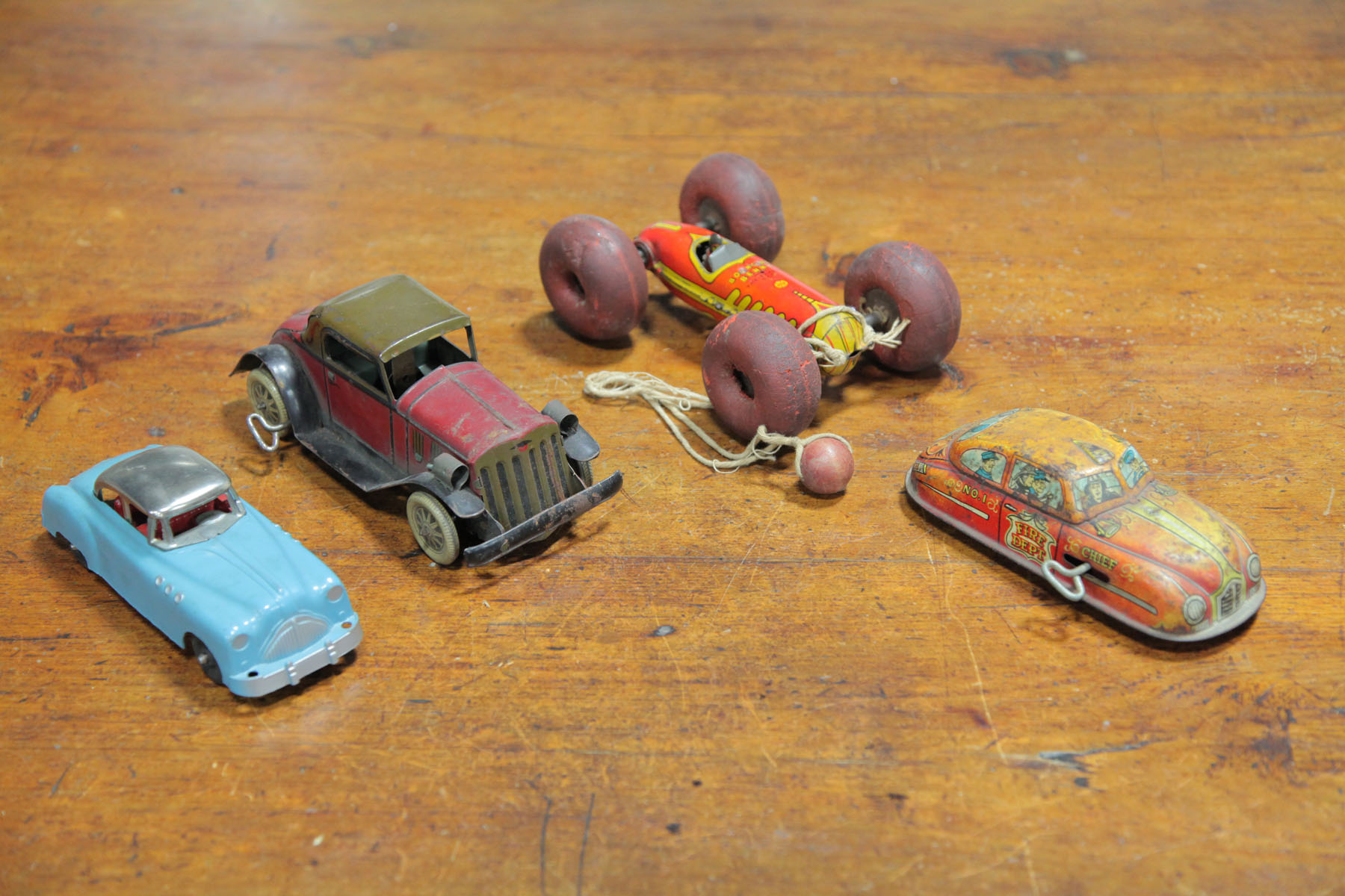 Appraisal: FOUR TOY CARS American second quarter of th century Lithographed