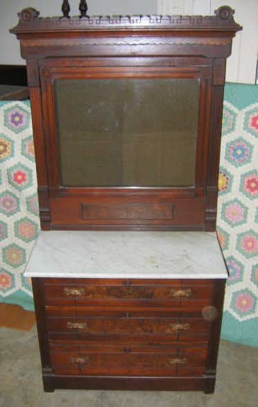 Appraisal: AMERICAN RENAISSANCE REVIVAL WALNUT DRESSER Showing a rectangular revolving mirror