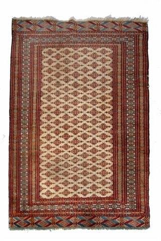 Appraisal: A CAUCASIAN IVORY GROUND RUG with central panel within a