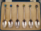 Appraisal: A boxed set of six silver teaspoons with enamelled national