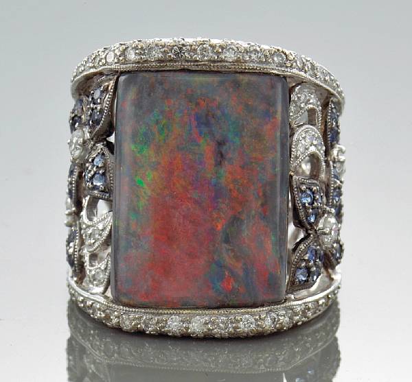 Appraisal: A opal diamond and sapphire ring centering a rectangular-shaped opal