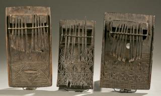 Appraisal: thumb pianos with carved linear motifs West African mancala game