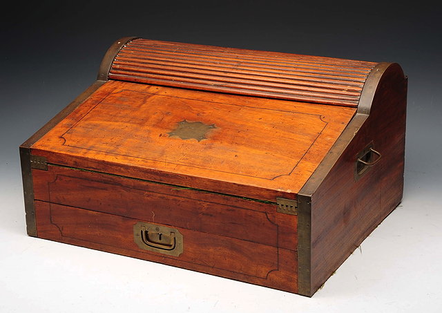 Appraisal: A CAMPAIGN BRASS BOUND CAMPHORWOOD WRITING BOX with tambour shutter