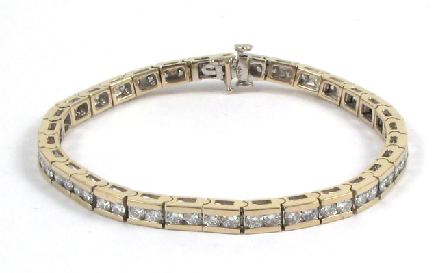 Appraisal: DIAMOND AND FOURTEEN KARAT GOLD BRACELET in length and set