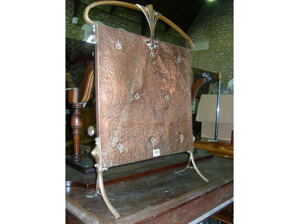 Appraisal: An Art Nouveau style fire screen with hammered brass panel