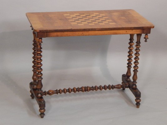 Appraisal: A Victorian walnut and marquetry games table the rectangular top