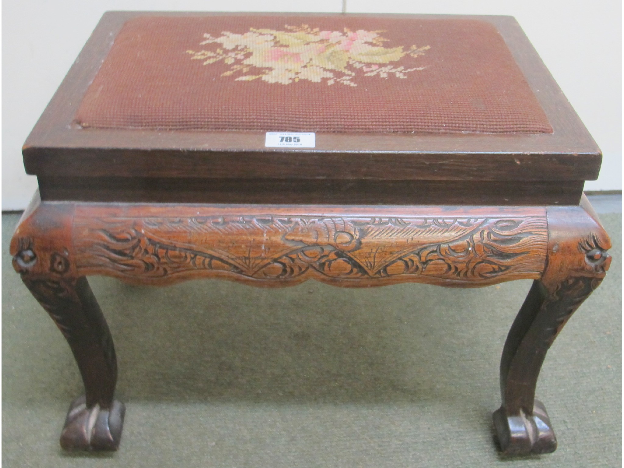 Appraisal: A mahogany carved tapestry footstool