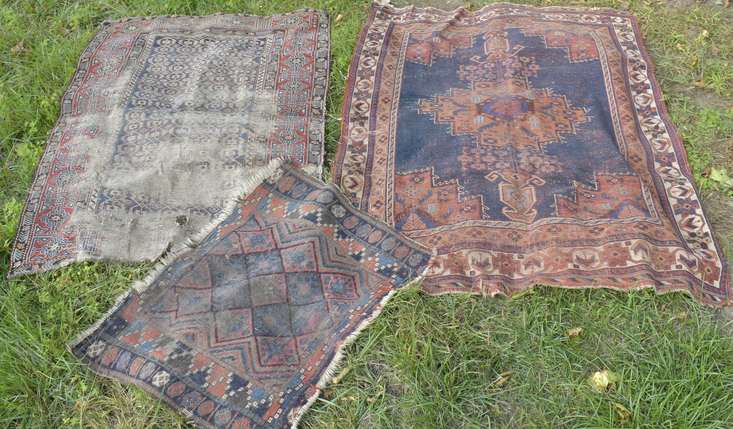 Appraisal: THREE WORN ANTIQUE ORIENTAL SCATTER RUGS Three heavily worn antique