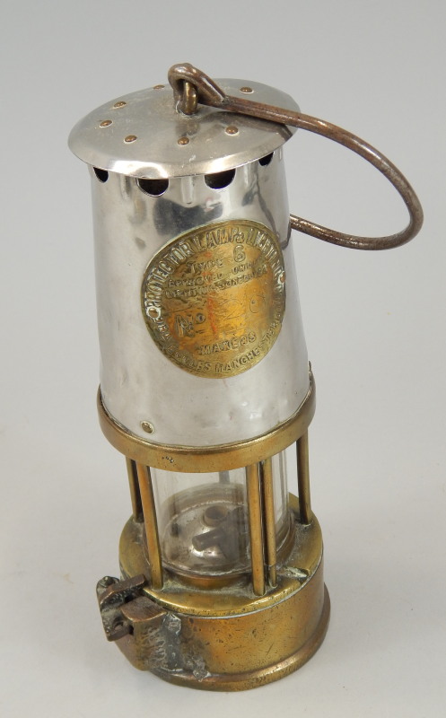 Appraisal: A brass and polished steel miner's lamp the Protector Lamp