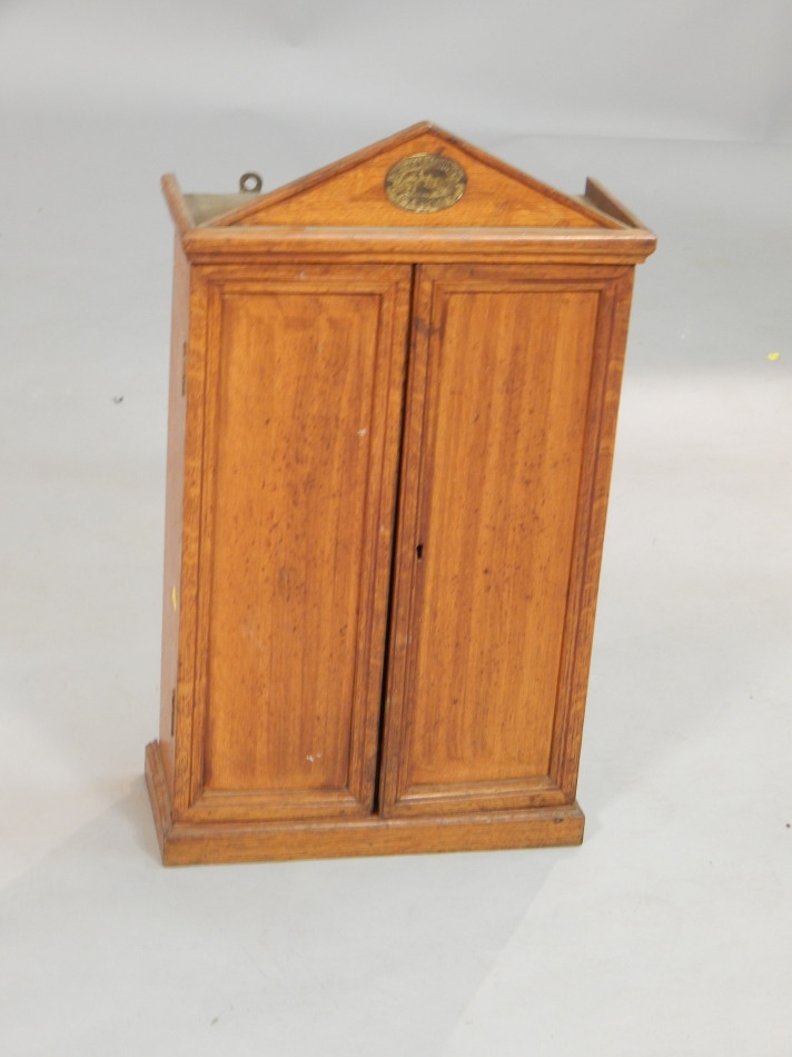 Appraisal: An Army and Navy registered oak tool cabinet with an