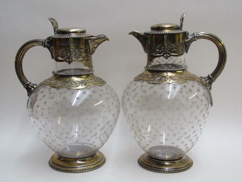 Appraisal: A pair of Victorian silver gilt mounted claret jugs the